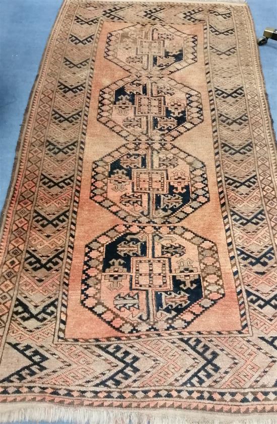 A Caucasian red ground rug 215 x 118cm